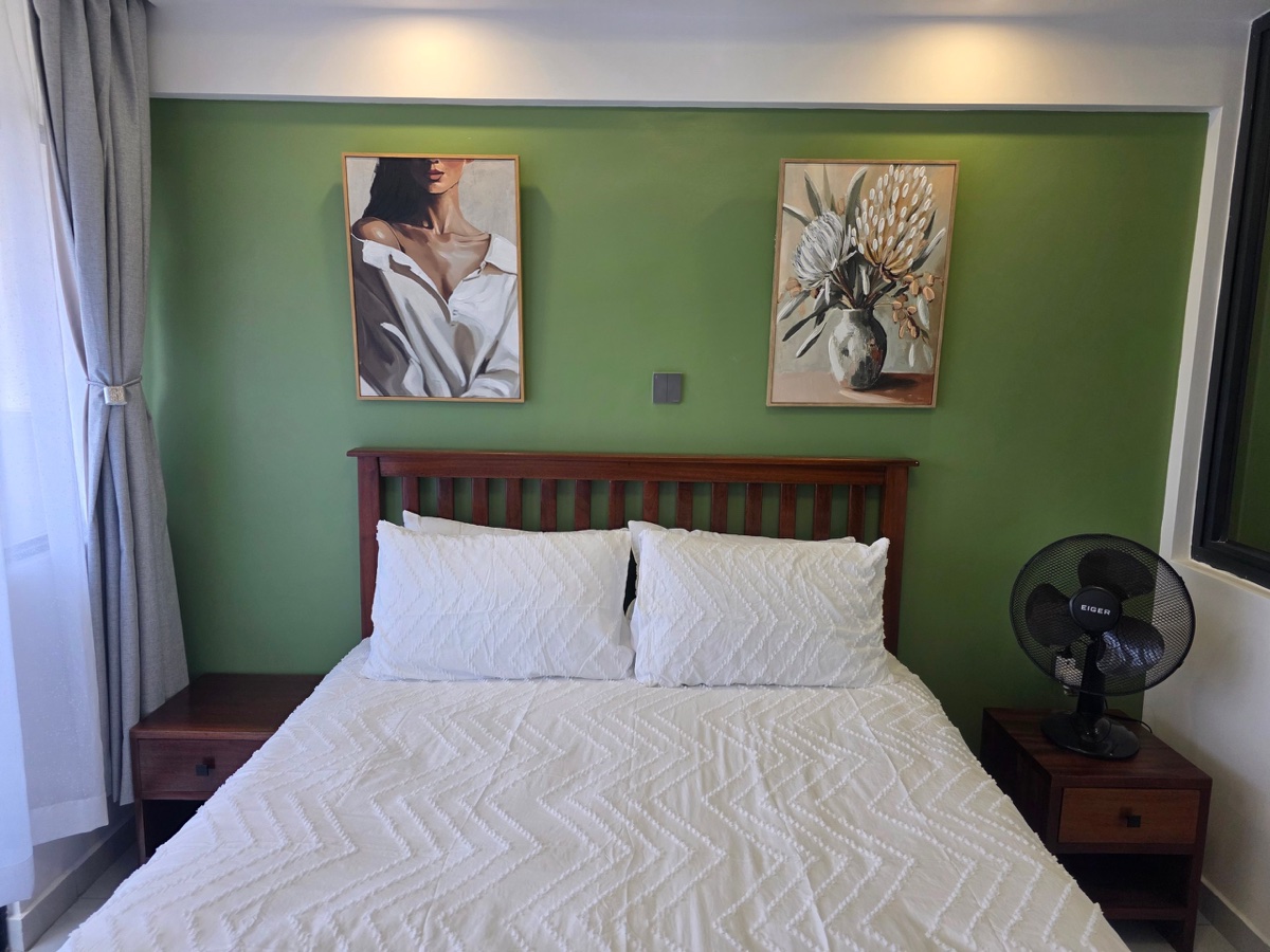 Bedroom with green accent wall