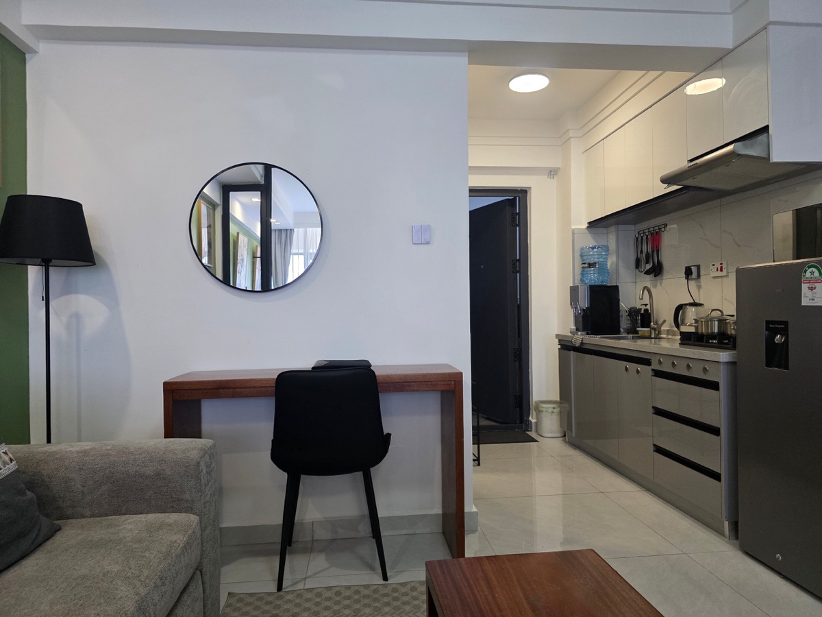 Living area with workspace and kitchen